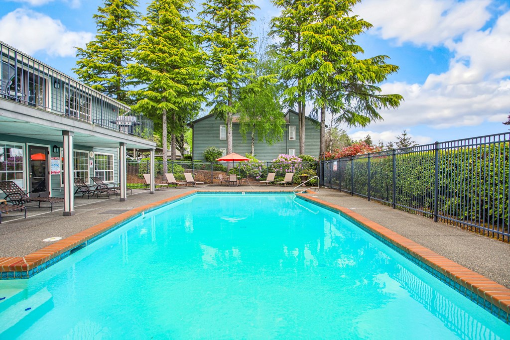 a swimming pool with a house in the background