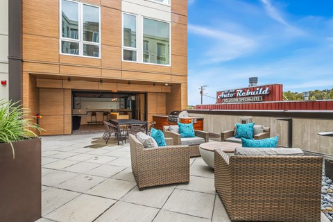 a patio with chairs and a table outside of a hotel
