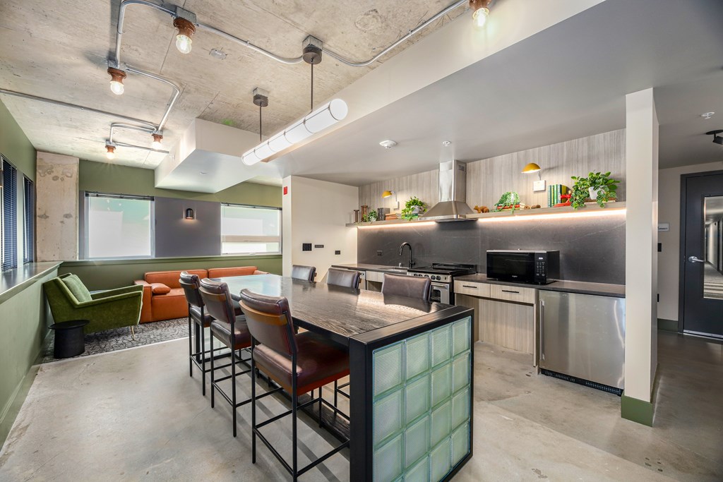 A modern kitchen with a long table and chairs.