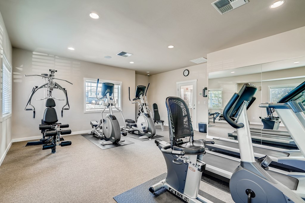 A spacious home gym with a variety of exercise equipment.