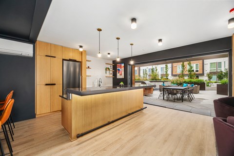 a kitchen with a large island and a dining room with a table and chairs
