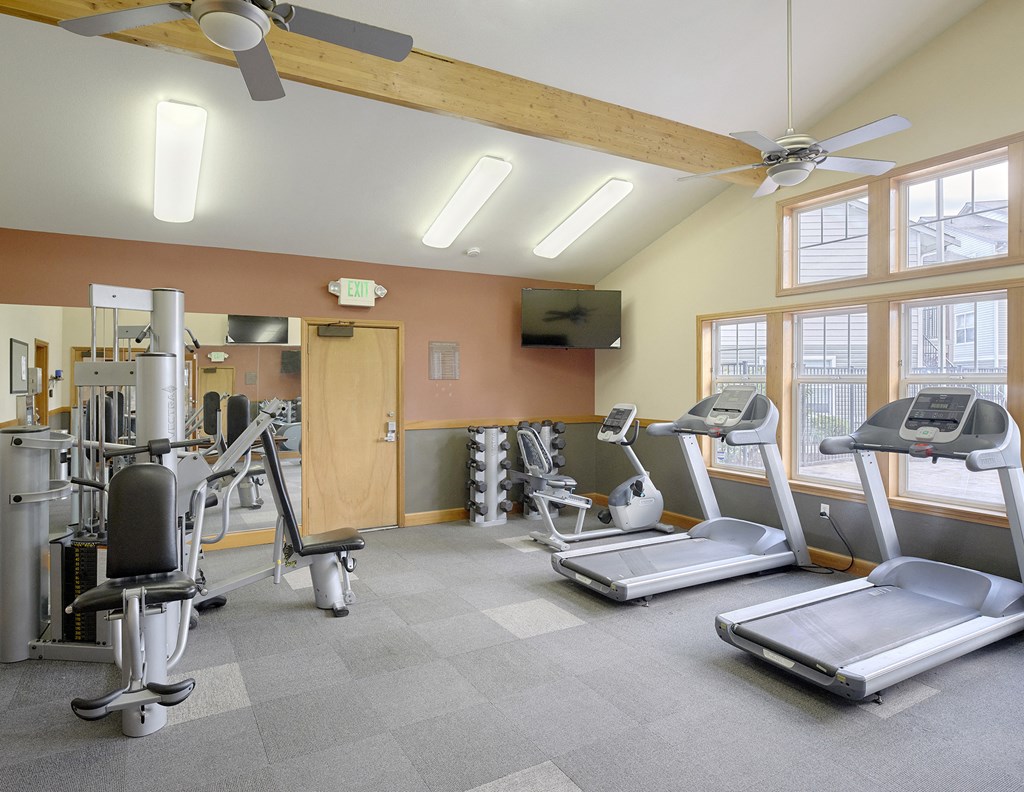a gym with treadmills and other exercise equipment
