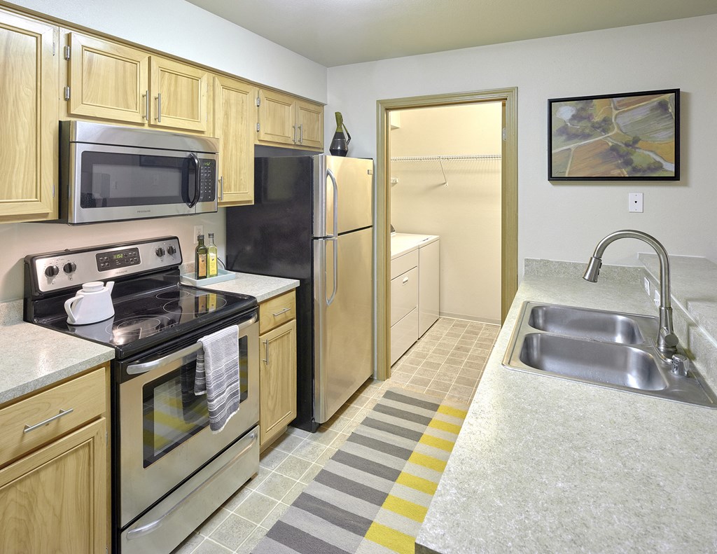 a kitchen with stainless steel appliances and wooden cabinets