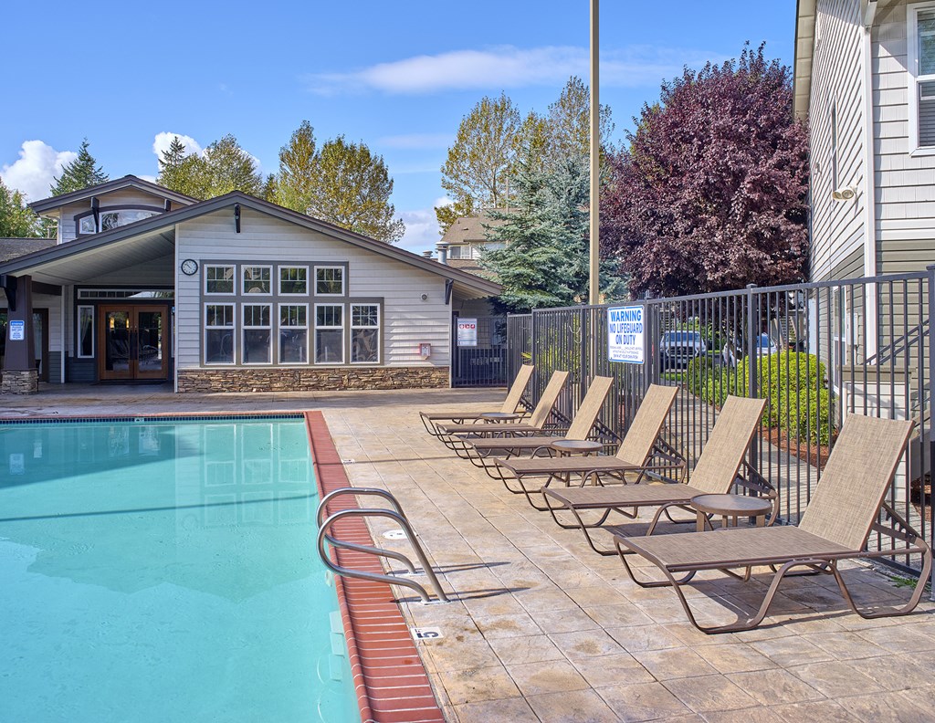 our swimming pool is in front of our building with lounge chairs