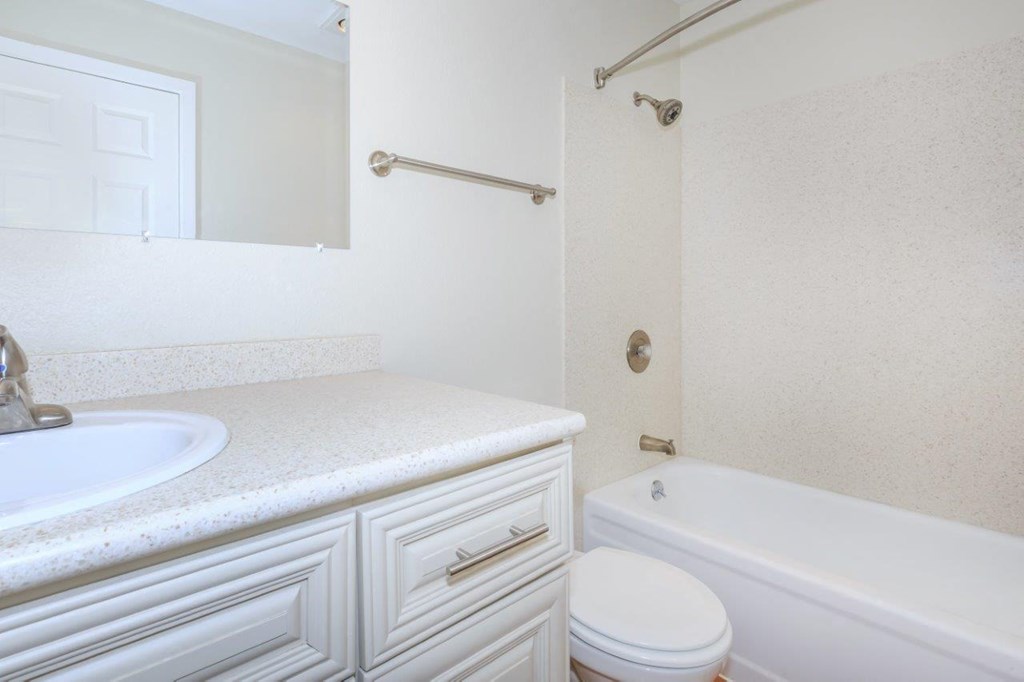 a bathroom with a sink toilet and a tub