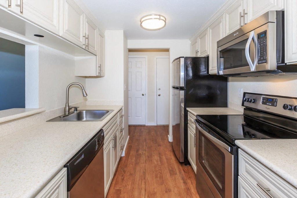 a kitchen with black appliances and white cabinets