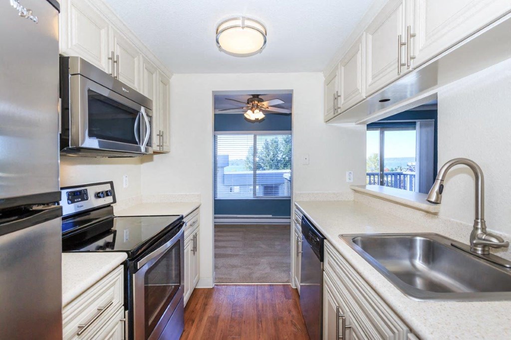 a kitchen with stainless steel appliances and white cabinets