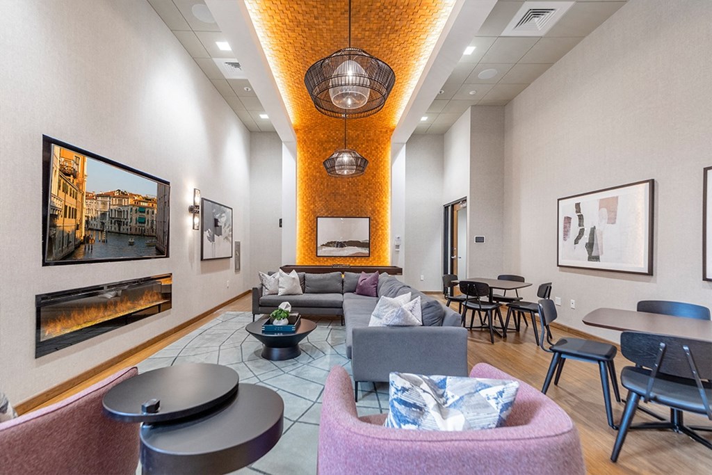 a living room with couches and chairs and a fireplace