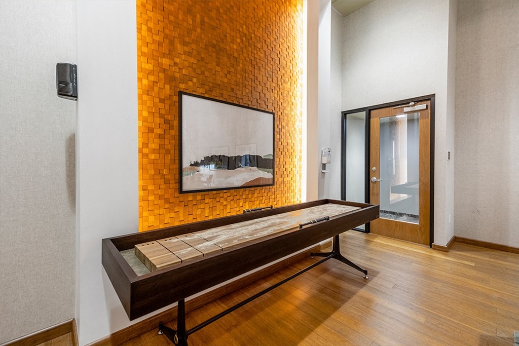 a large room with a bench in front of a yellow brick wall