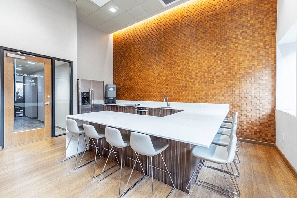 a conference room with a long table and chairs and a brick wall