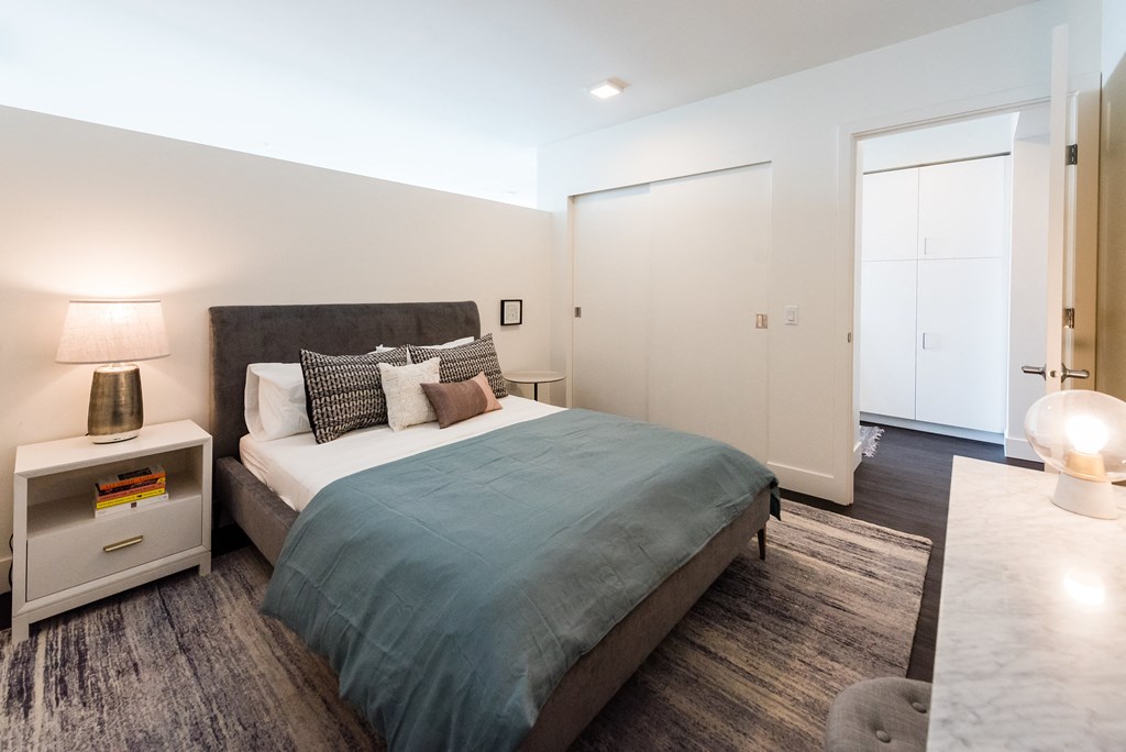 a bedroom with a bed and desk in a 555 waverly unit