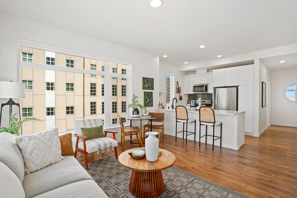A living room with a grey couch and a wooden coffee table.