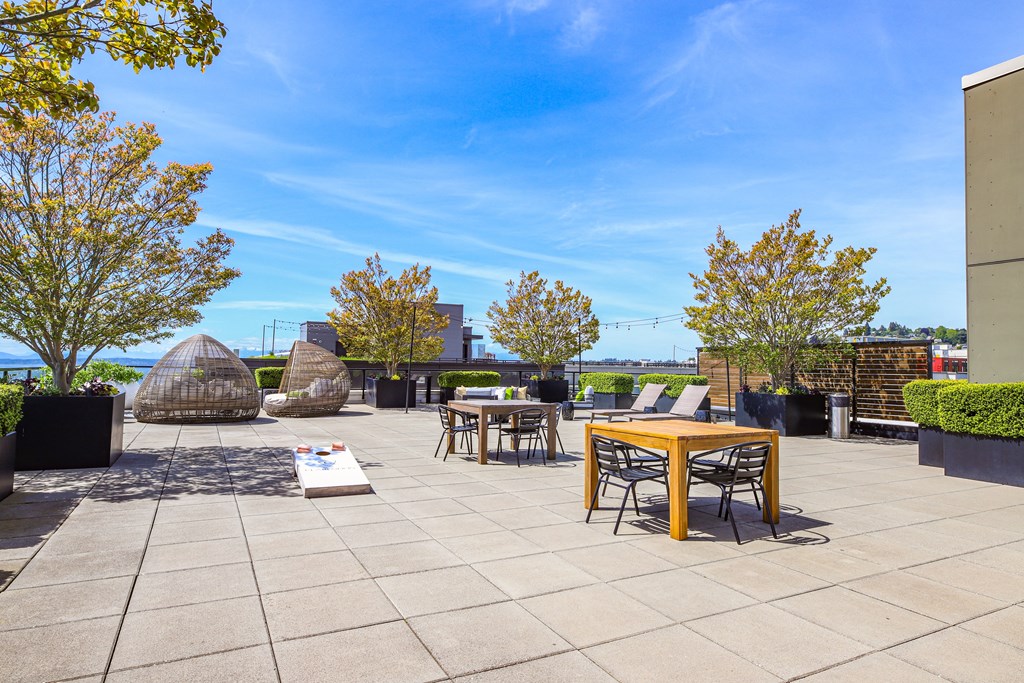an outdoor patio with tables and chairs on a sunny day