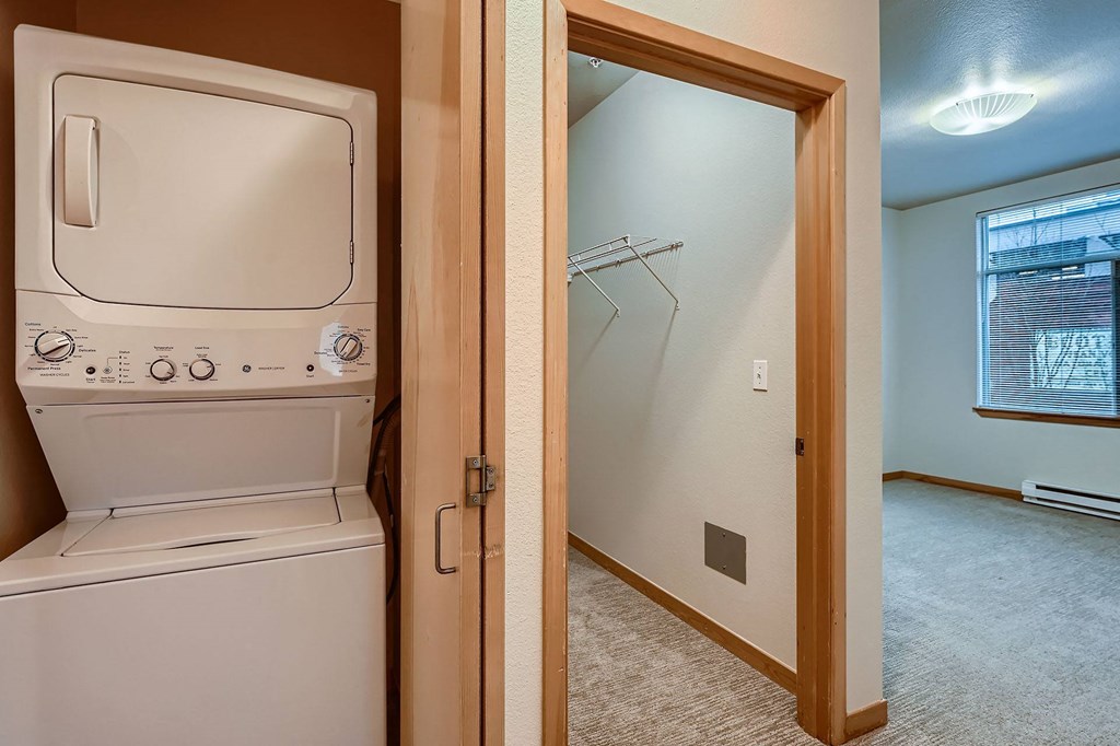a laundry room with a washer and dryer next to a door