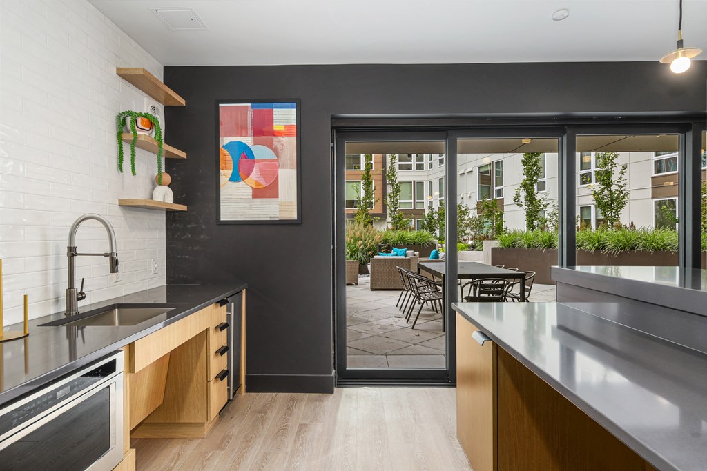 a kitchen with stainless steel counter tops and a patio