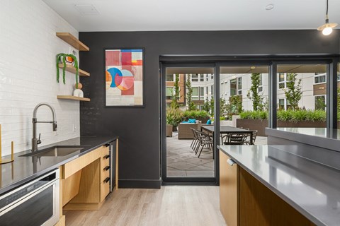 a kitchen with stainless steel counter tops and a patio