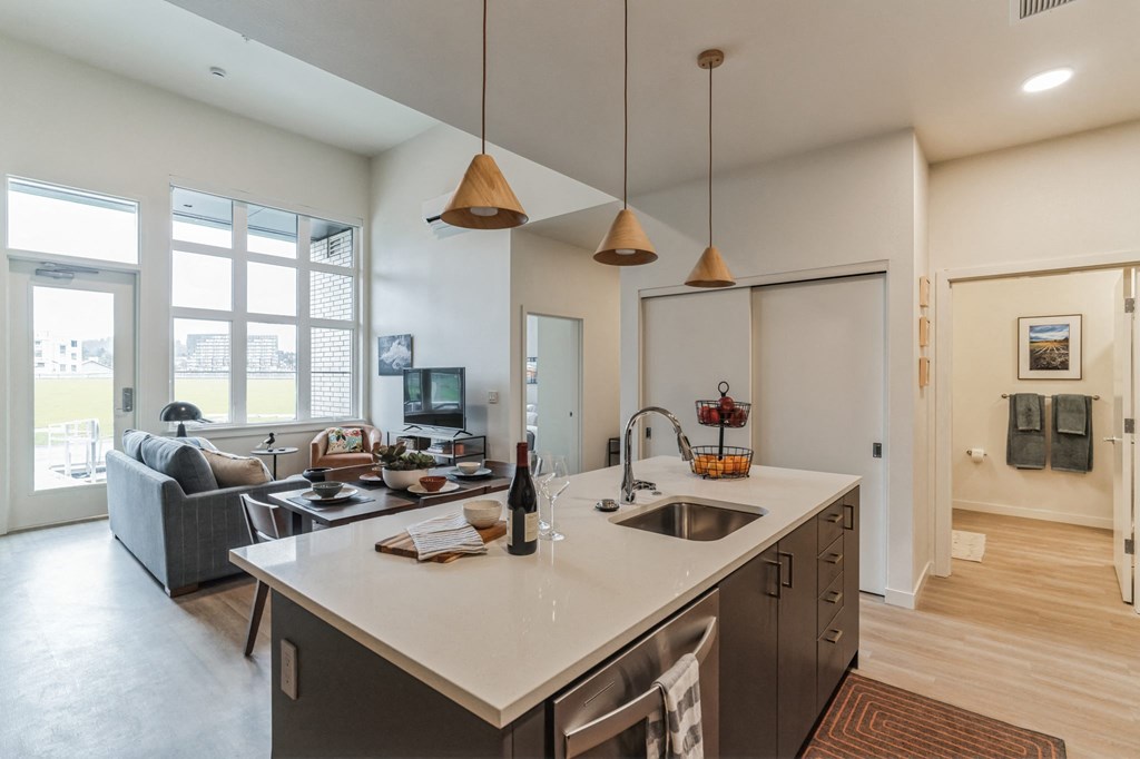 a kitchen with an island and a living room with a couch