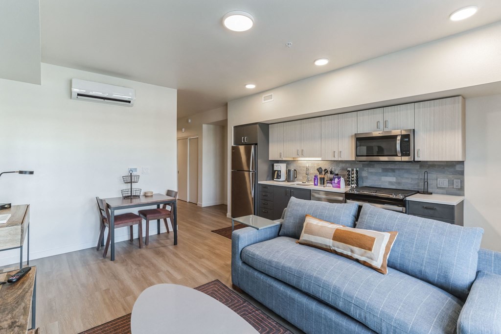 a living room with blue couches and a table