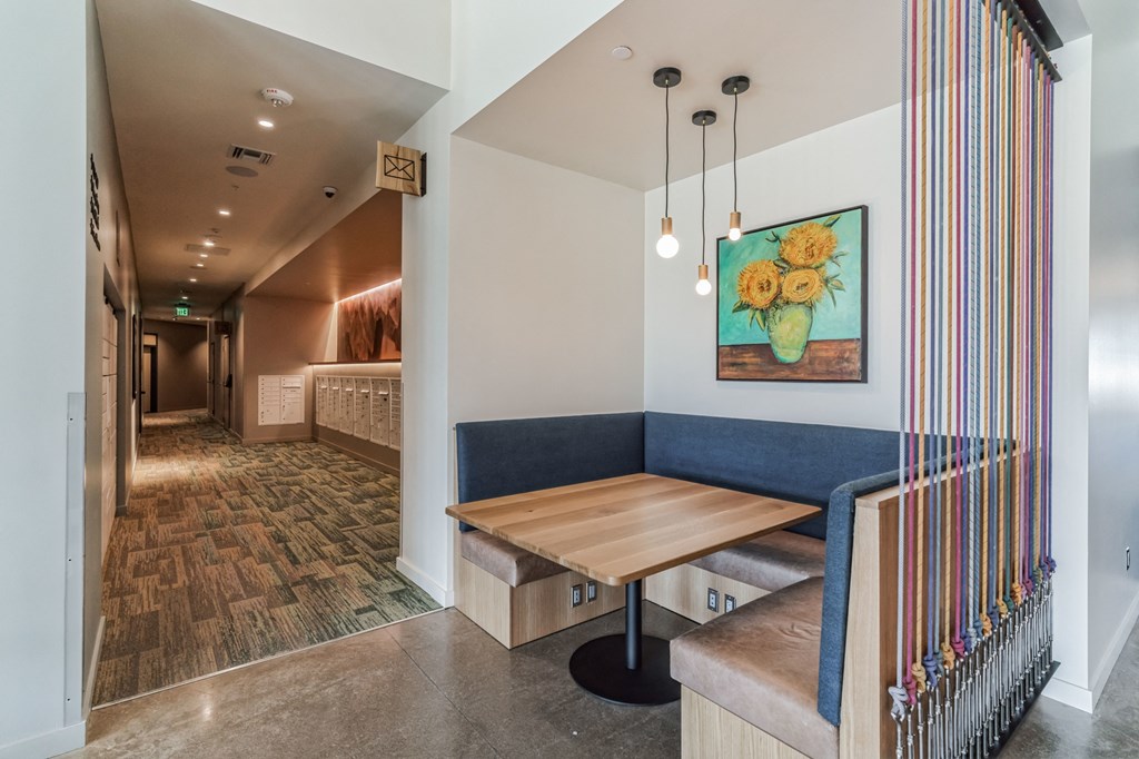 a dining area with a wooden table and a view of a hallway