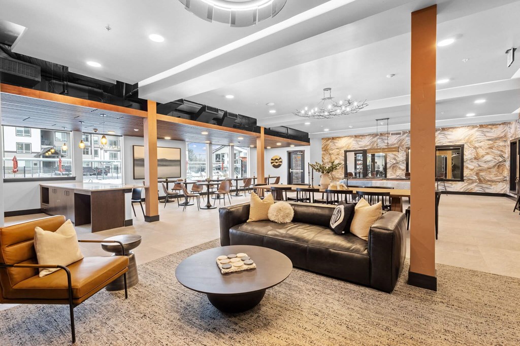 a lobby with couches and chairs and a table