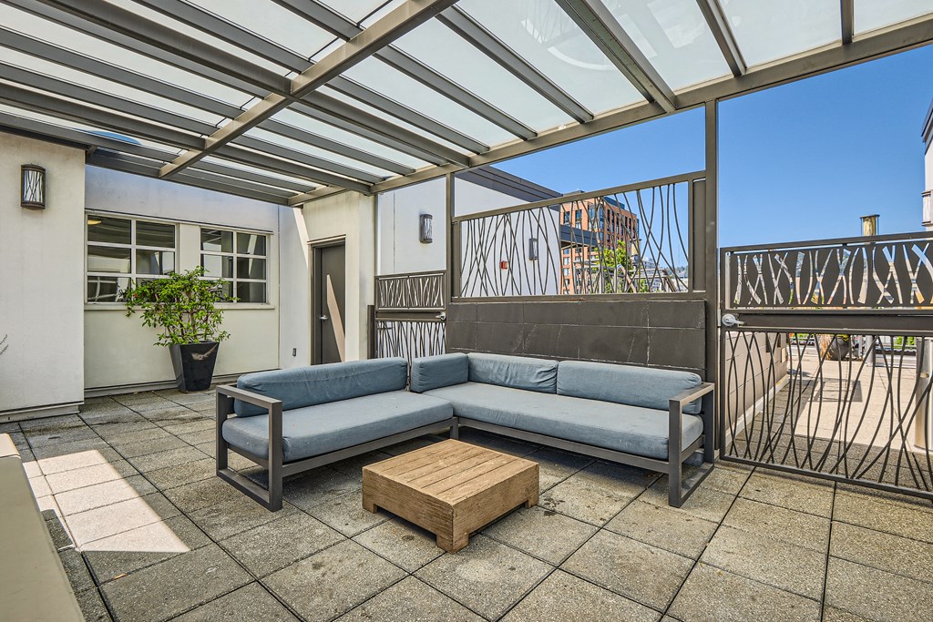 a living room with a couch and a coffee table on a patio