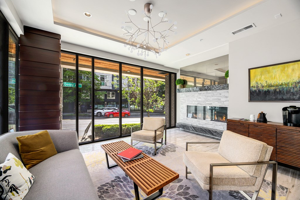 a living room with a couch and a coffee table and a fireplace