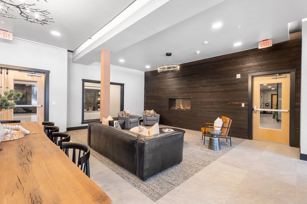 a living room with a couch and a table and a fireplace