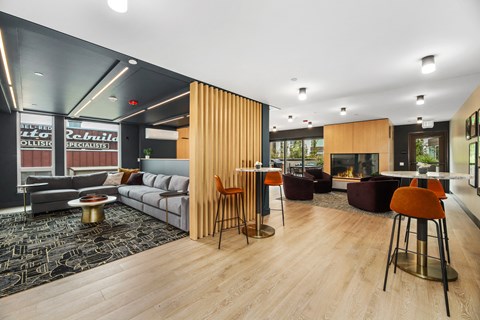 a living room with a couch and tables and a fireplace