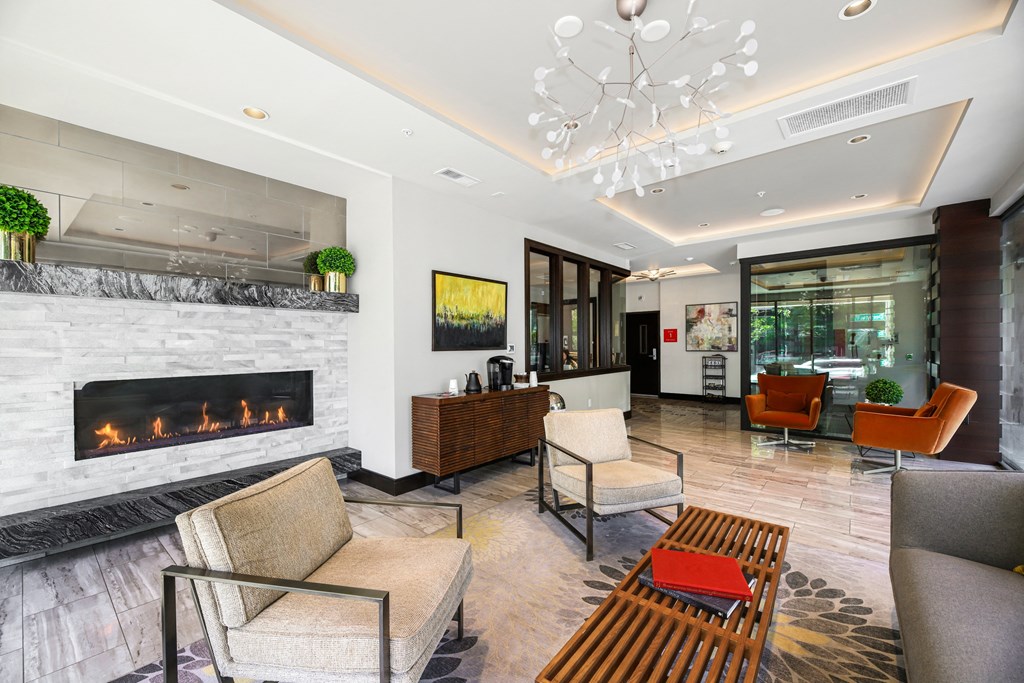 a living room with a fireplace and chairs