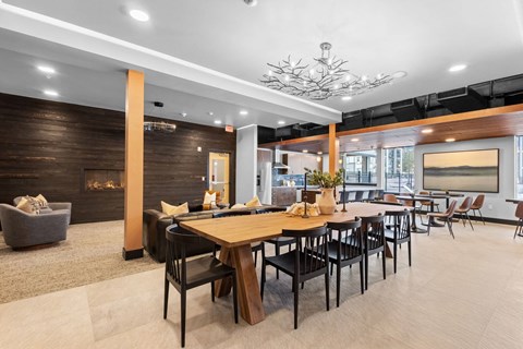 a dining area with tables and chairs and a fireplace