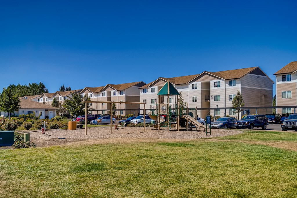 A row of houses with a playground in the foreground.