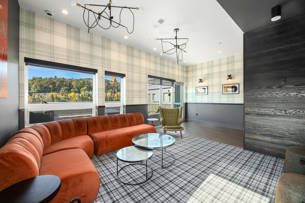 A modern living room with a red couch and a checkered floor.