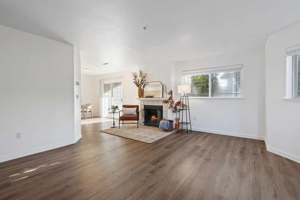 A living room with a fireplace and a chair.