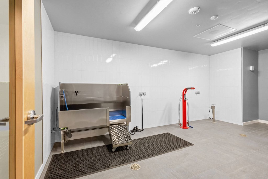 a room with a stainless steel stove and a red