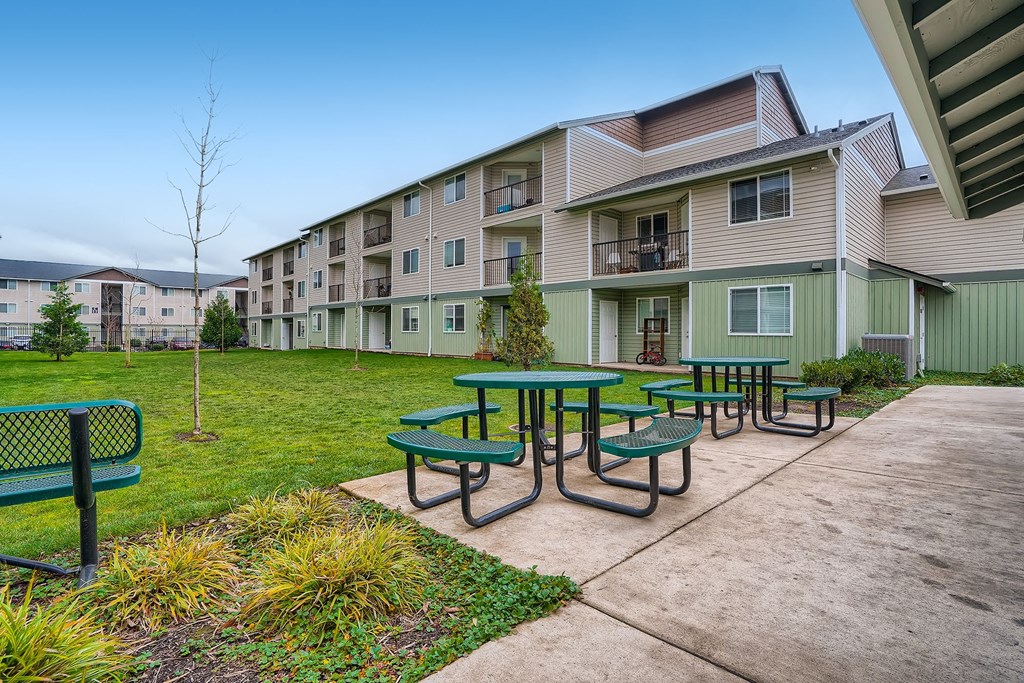 our apartments have a patio with tables and chairs