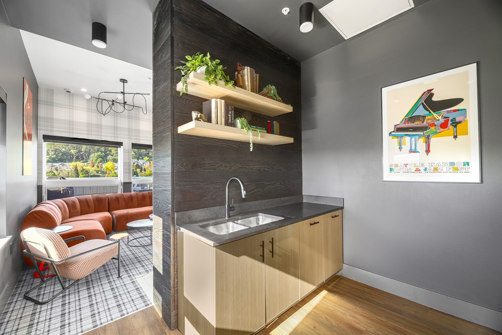 A kitchen with a brown counter top and a brown couch.