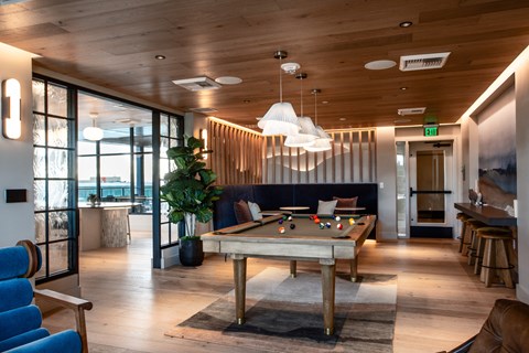 a large room with a pool table in the middle