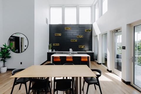 A modern dining room with a wooden table and chairs.