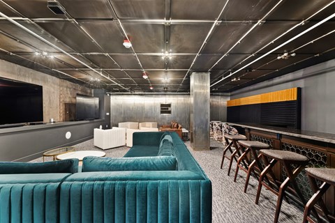 a room with couches and chairs and a bar