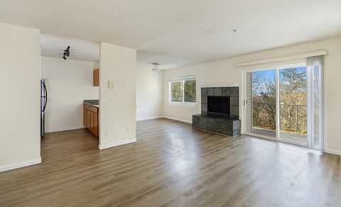 A living room with a fireplace and sliding glass doors.