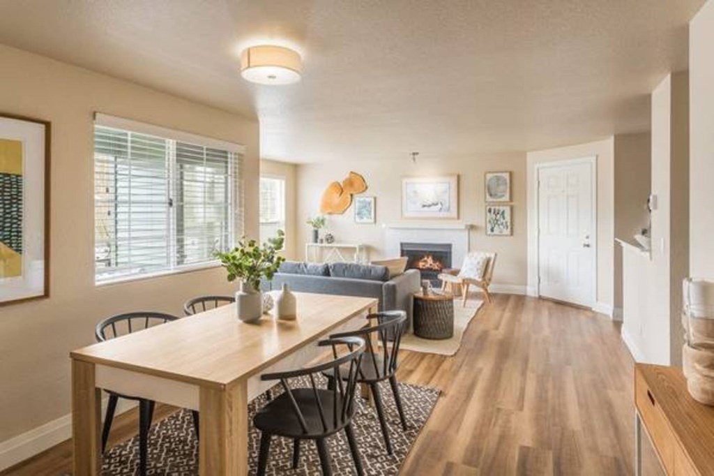 A dining room with a wooden table and chairs.