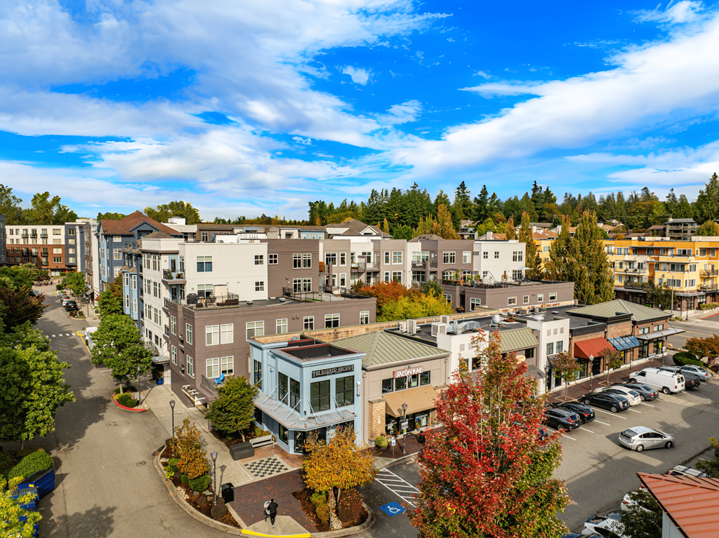 A street view of a small town with buildings and cars.
