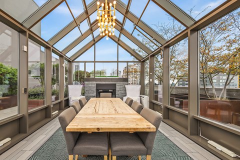 a dining room with a wooden table and chairs and a fireplace