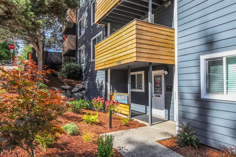 A modern house with a blue exterior and a yellow accent wall.