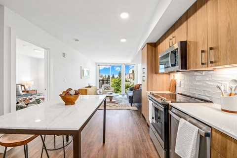 a kitchen with wooden cabinets and a white counter top