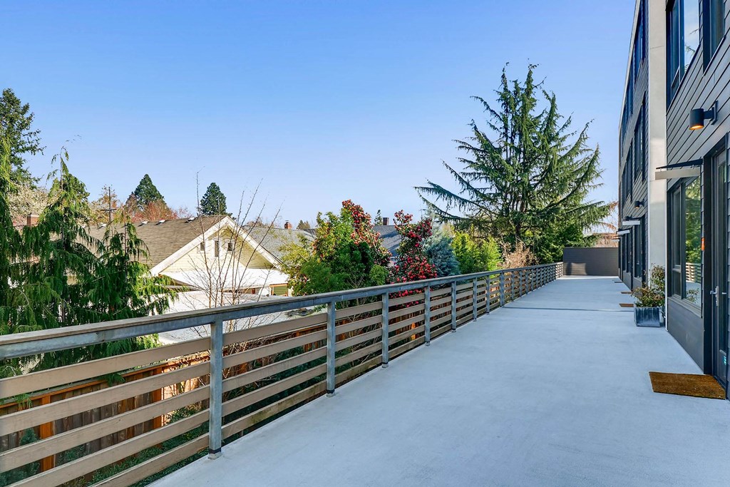 the balcony of a home with a large patio