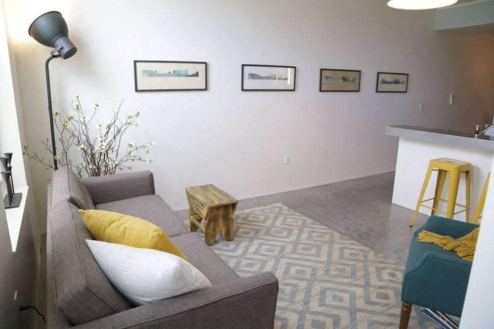 a living room with a couch and a bar