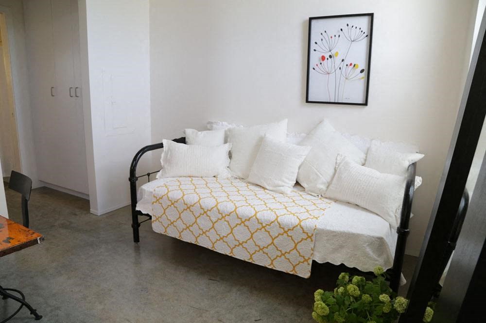 a living room with a couch and a painting on the wall