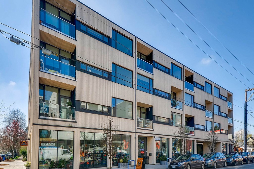 a view of a building with cars parked in front of it