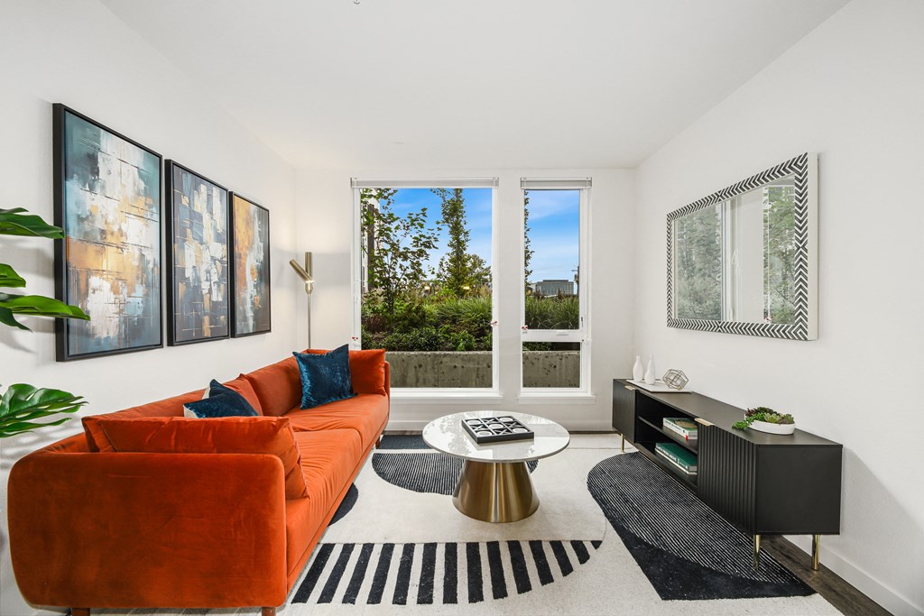 a living room with a orange couch and a coffee table